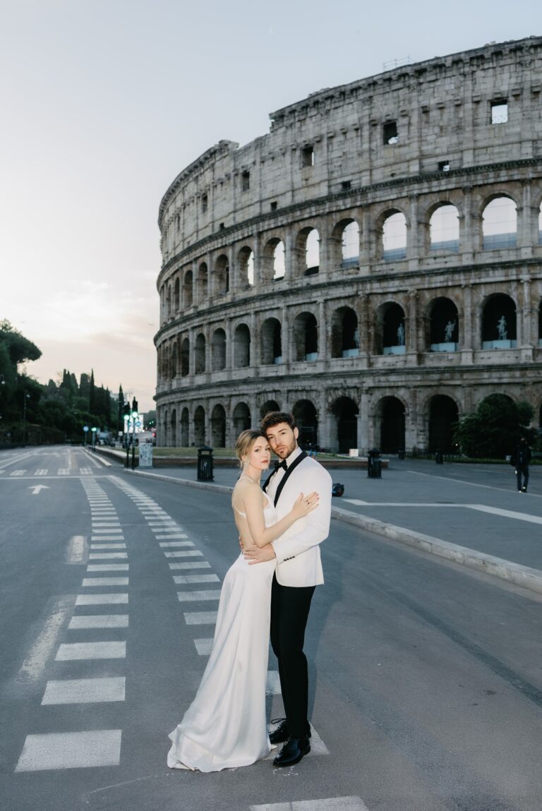 Couple on the empty road beside the Colosseum at 7:33am