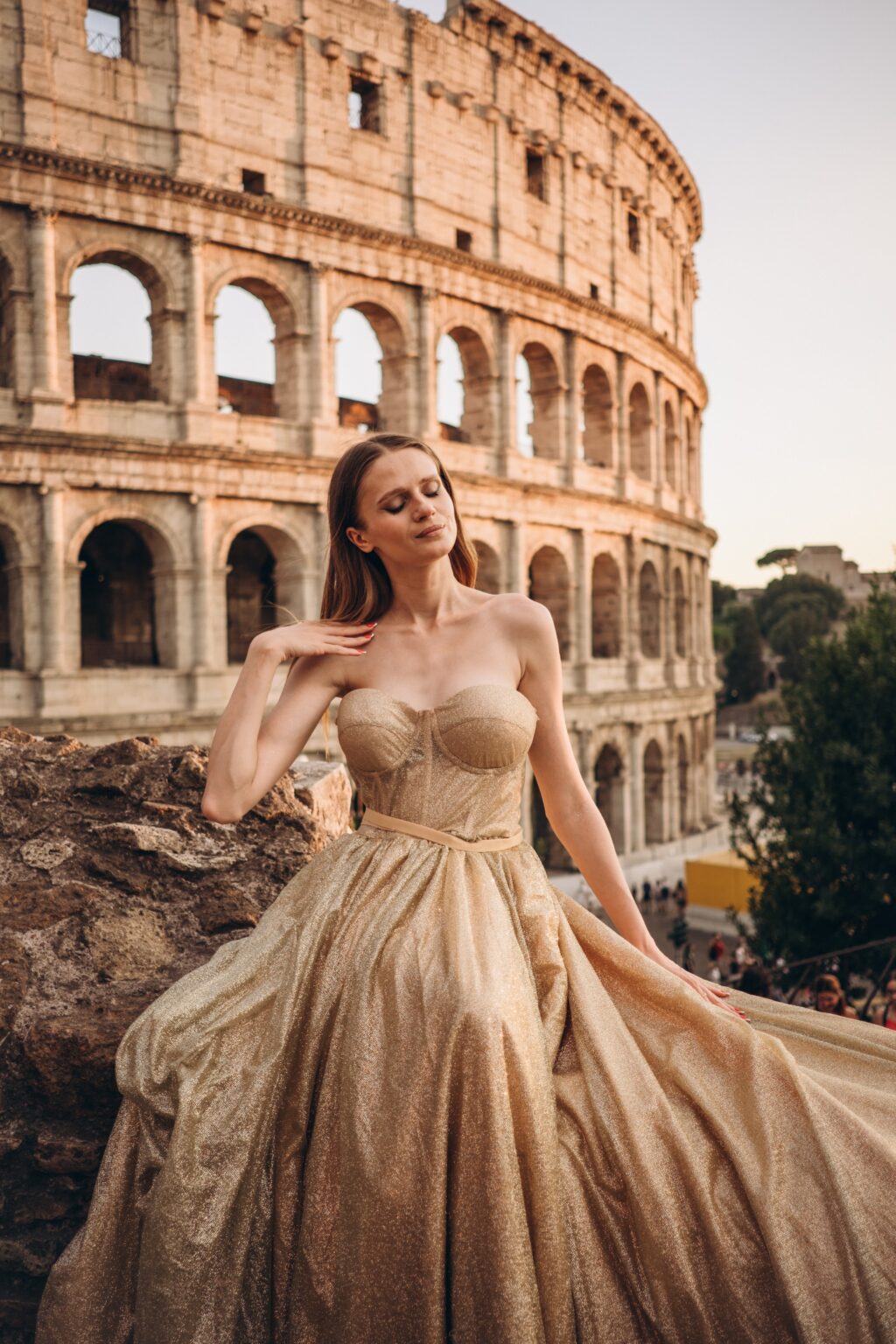 Gold gown in warm light with the Colosseum behind