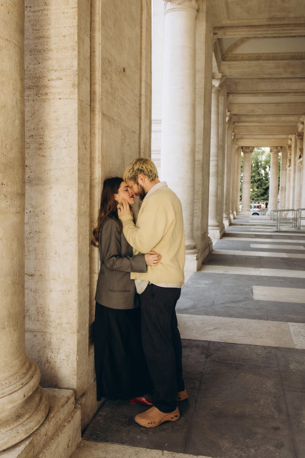 Couple kissing in the colonnade on the Capitoline Hill