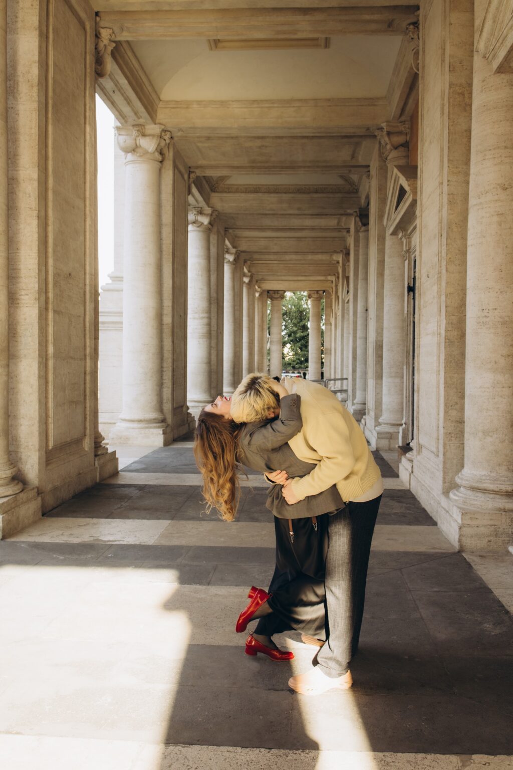 Couple in the sunlit Capitoline colonnade
