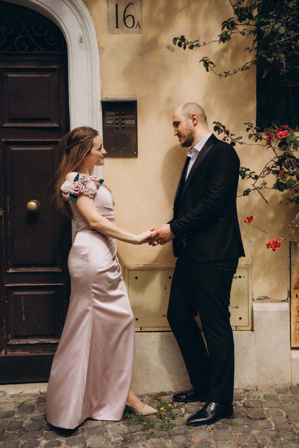 Couple by an ivy-covered doorway in Rome