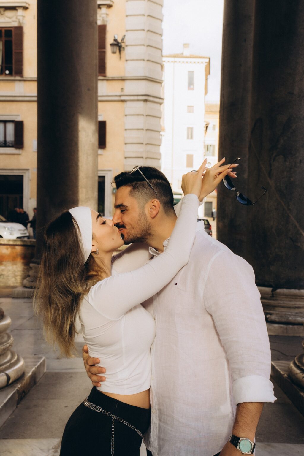 Couple kissing between the columns of the Pantheon, Rome