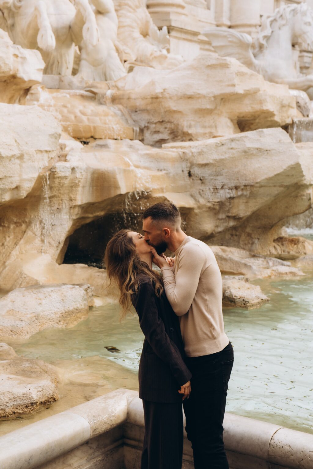 Couple kissing at the Trevi Fountain in Rome