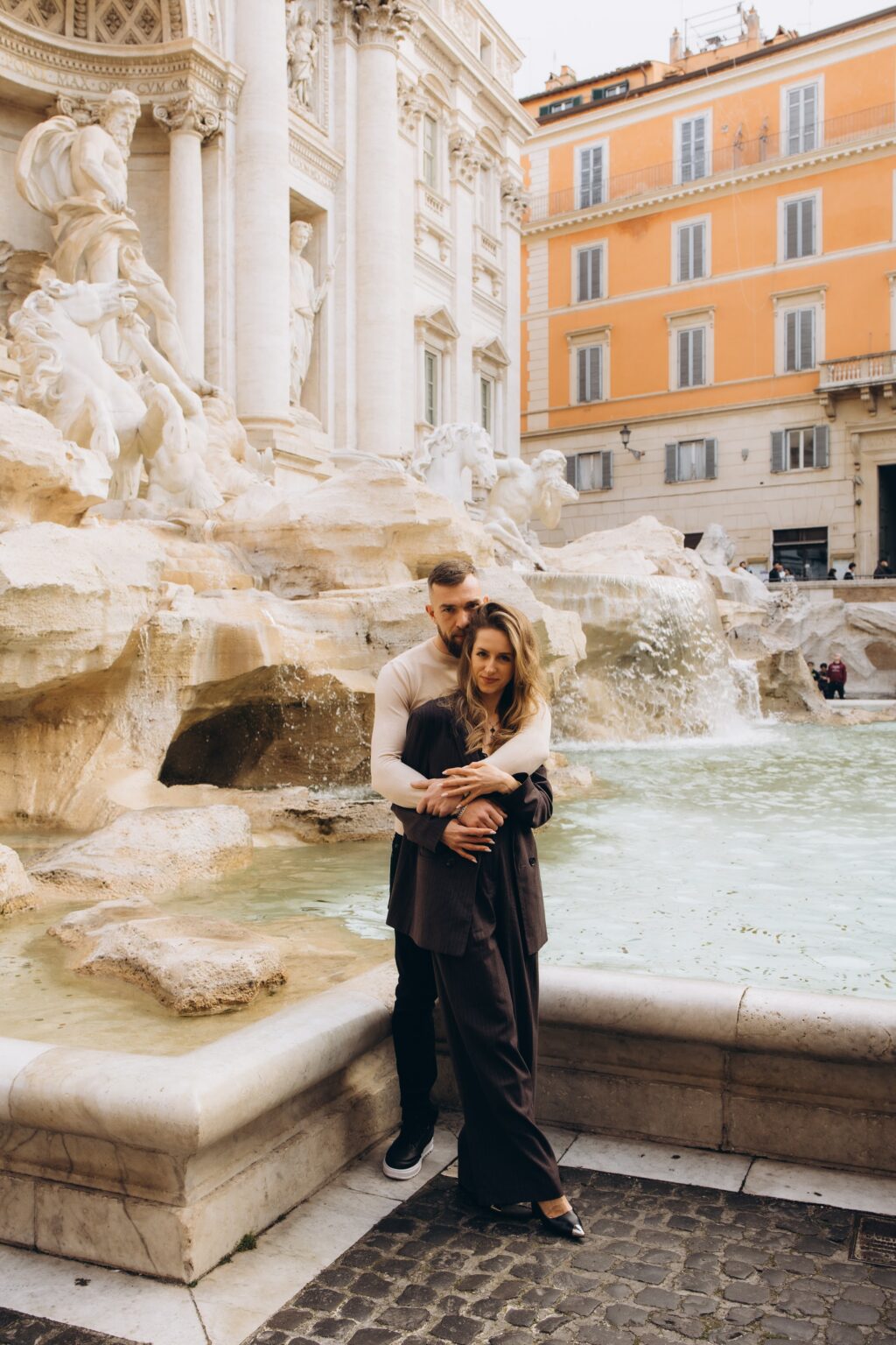 Couple at the Trevi Fountain on a grey March morning