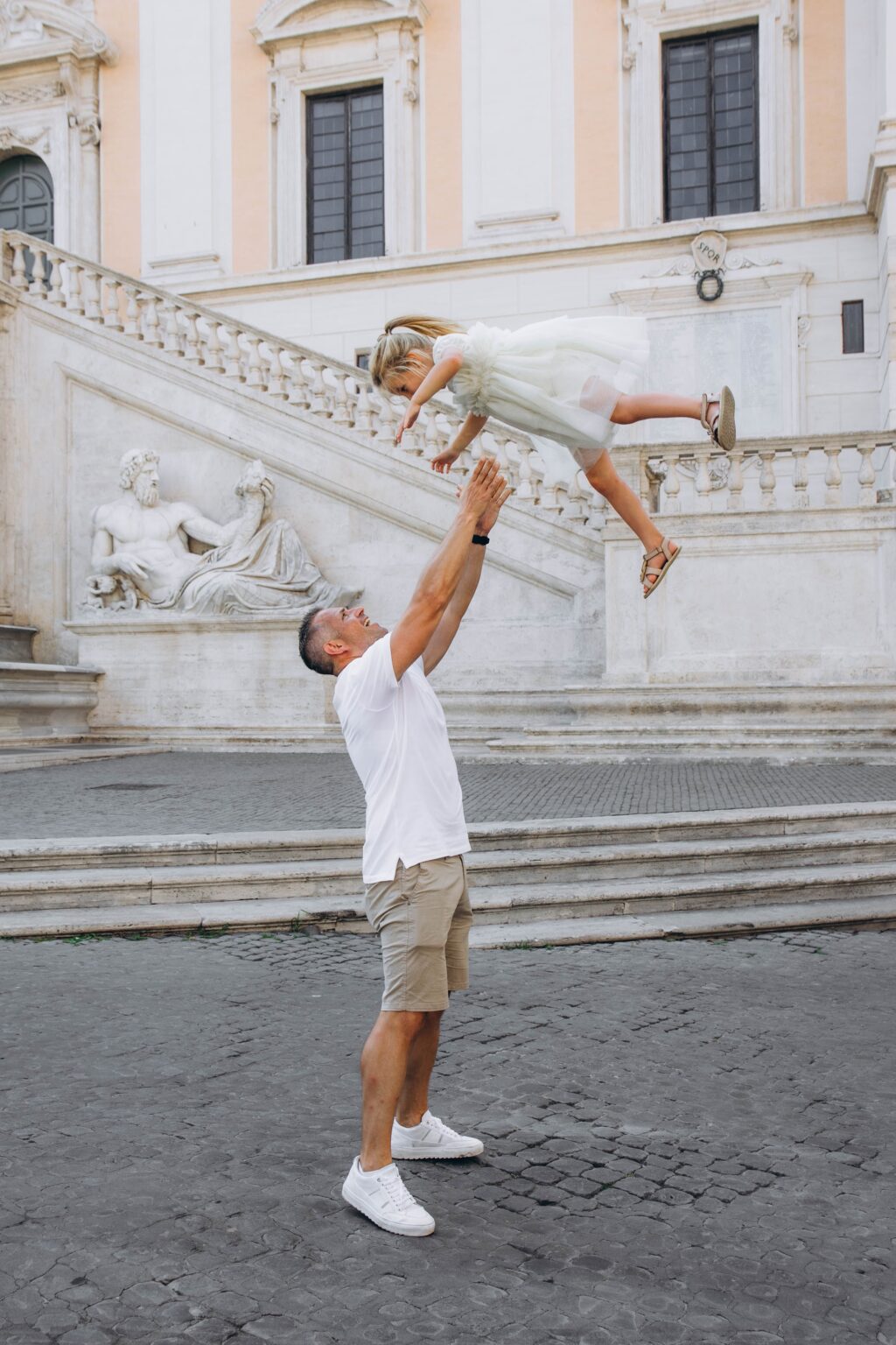 Dad lifting his daughter on the Capitoline Hill
