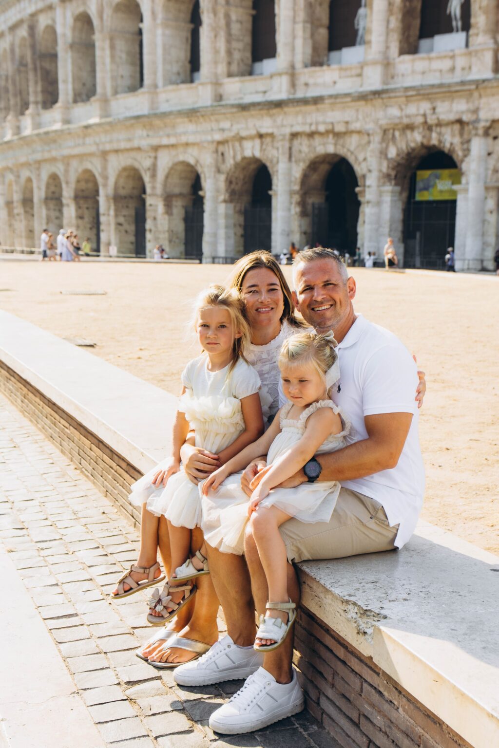 Family with two daughters at the Colosseum on a July morning
