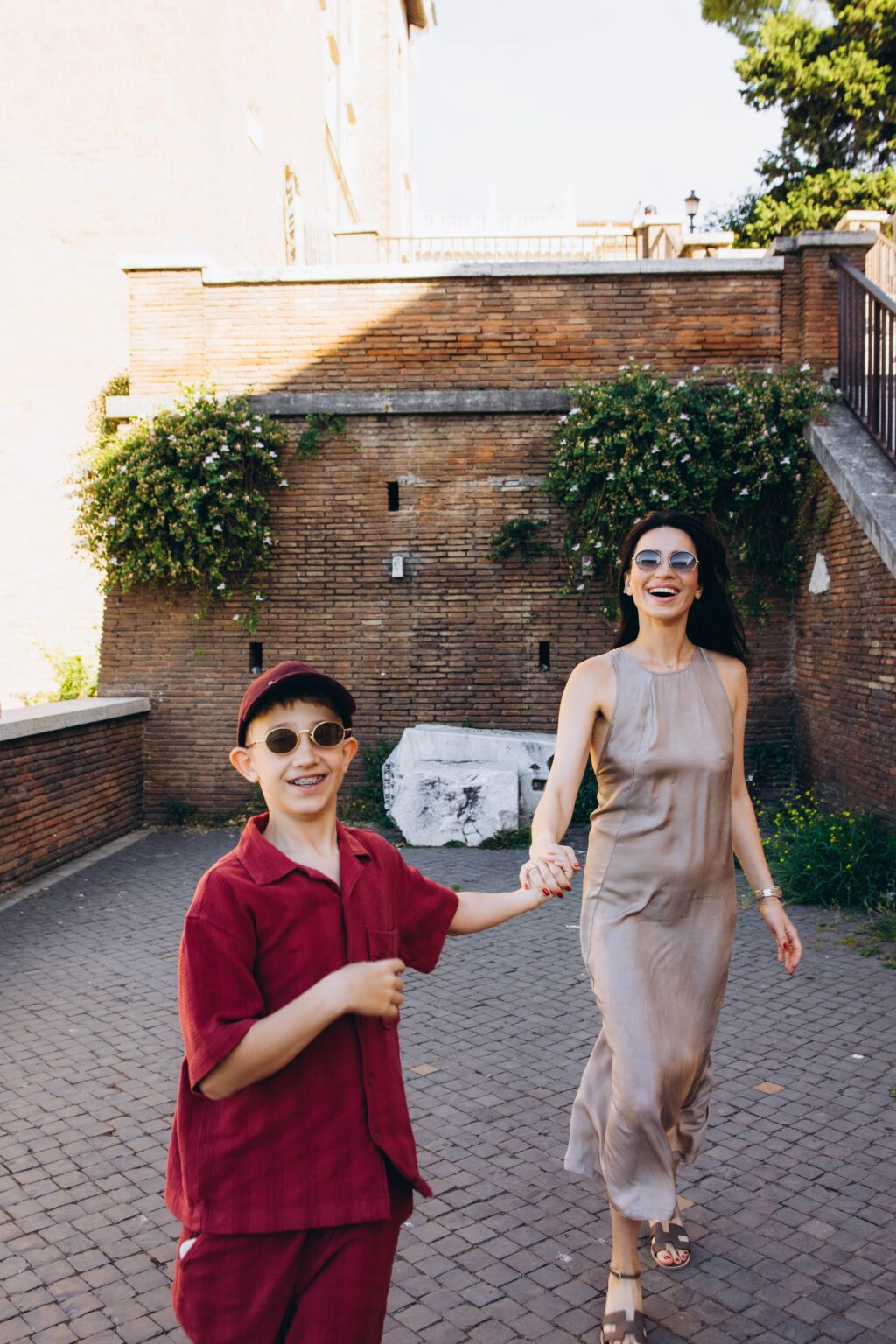 A boy laughing and holding hands on the walk up to the Capitoline Hill