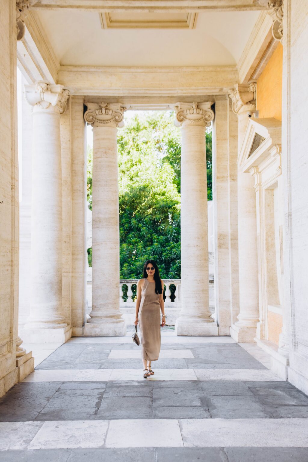 Walking through the portico of the Capitoline Museums, June morning