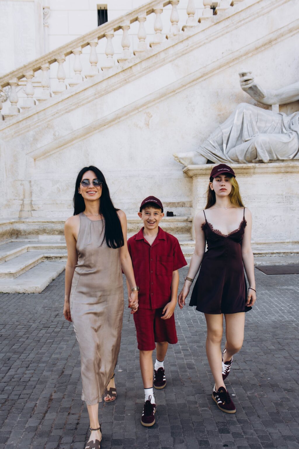 Three travellers walking below the Capitoline stairs and the Marforio statue