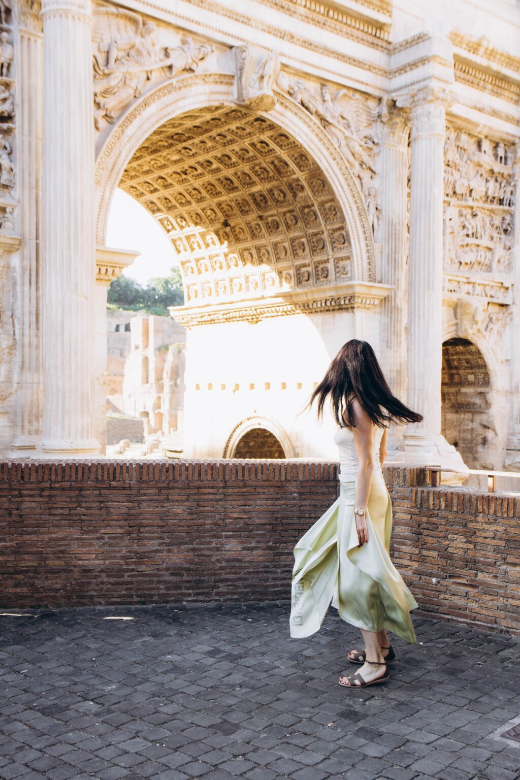 Twirling in a flowing skirt under the Arch of Septimius Severus above the Roman Forum