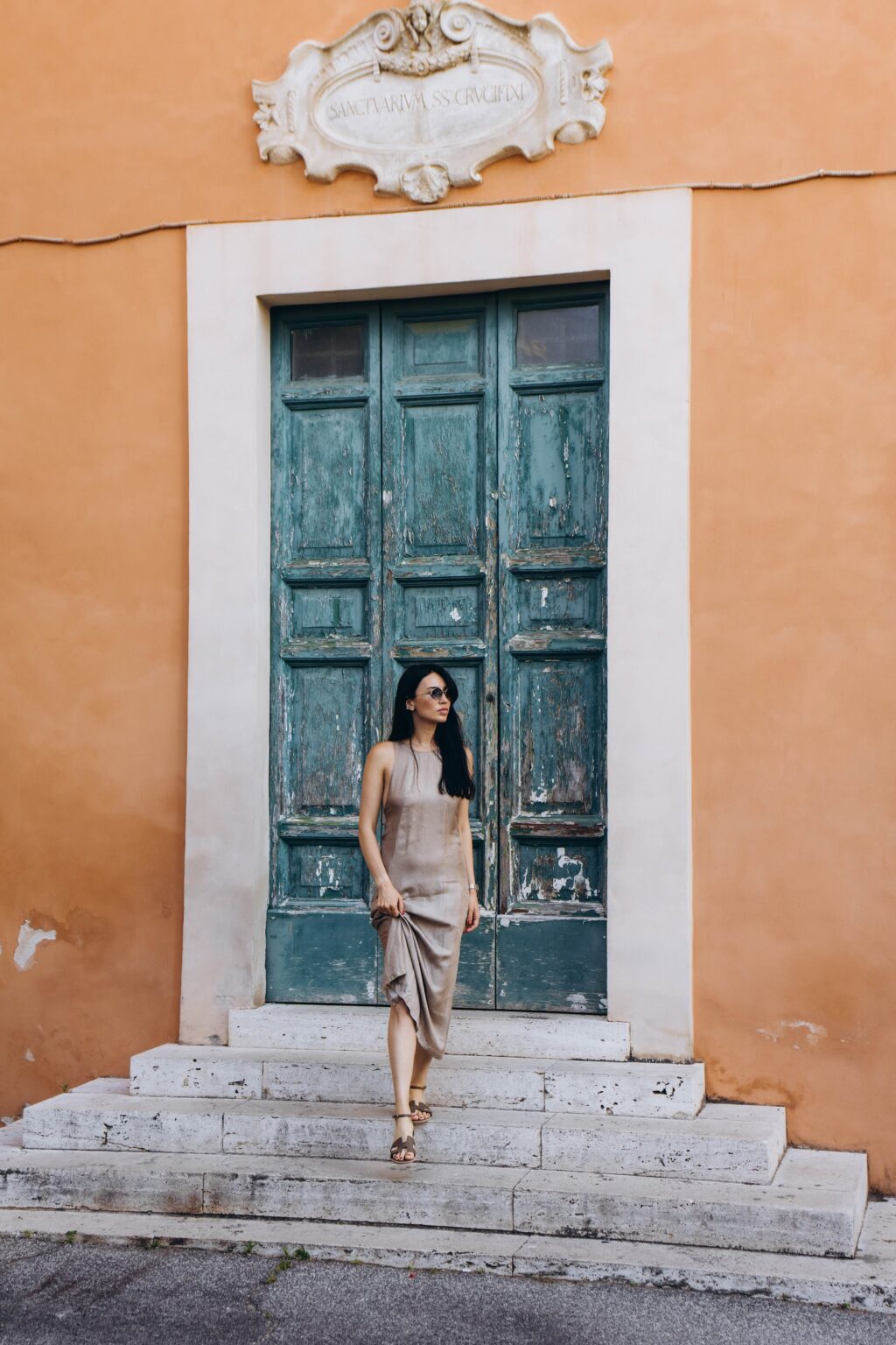 Portrait by a green door in an orange wall near the Capitoline Hill