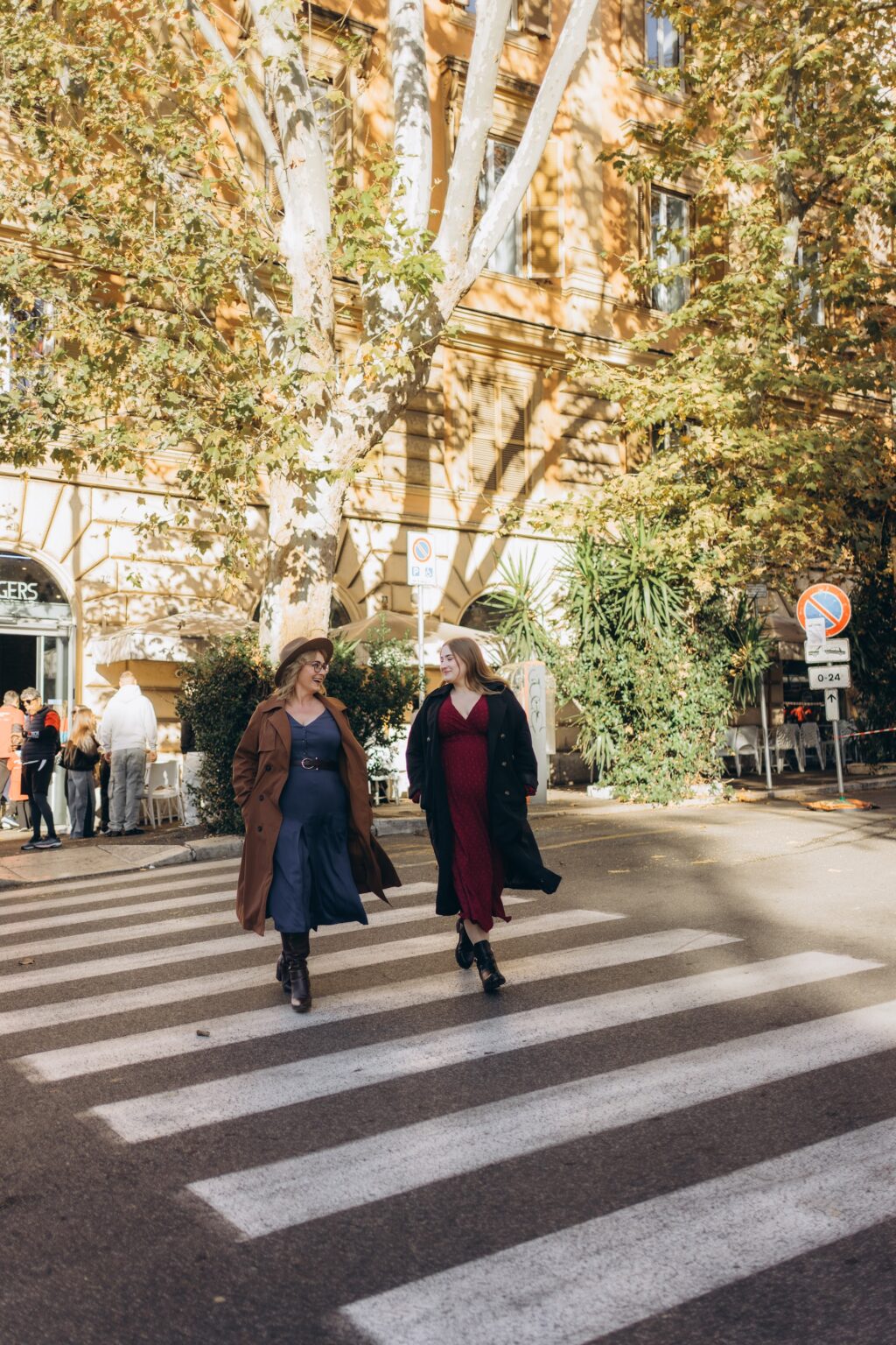 Crossing a street under autumn plane trees in Rome