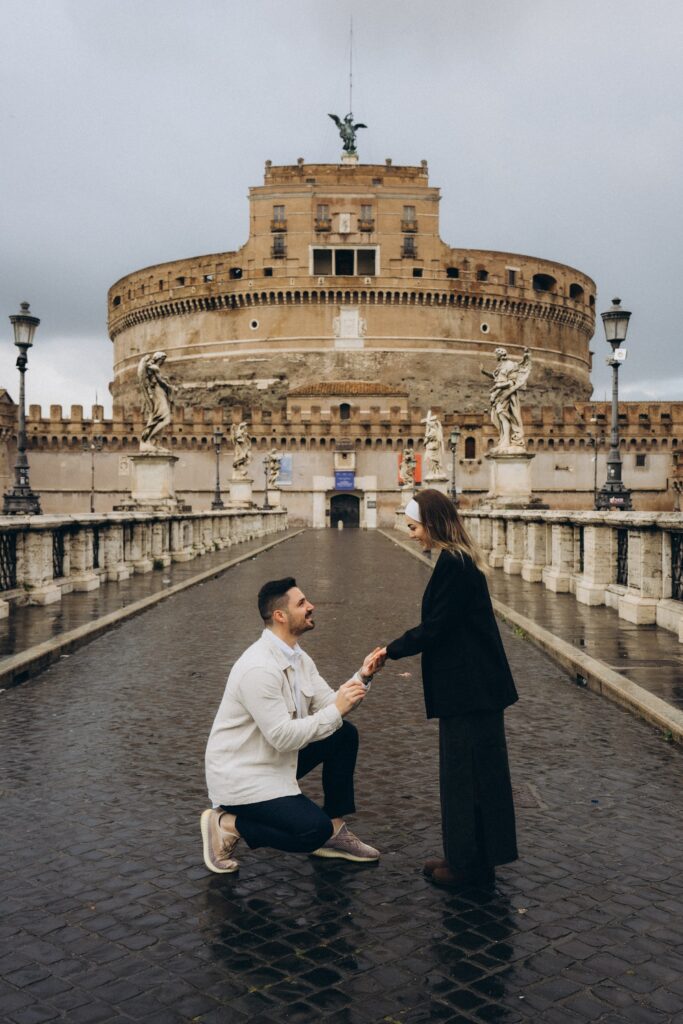 Marriage proposal on Ponte Sant'Angelo with Castel Sant'Angelo behind