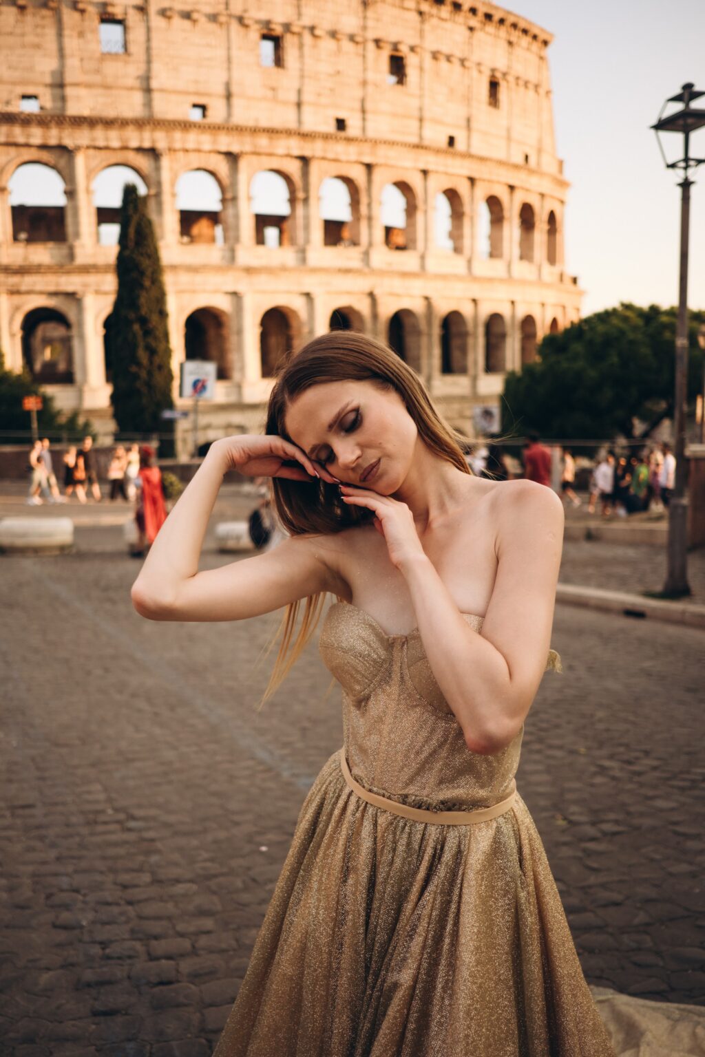 Solo photoshoot in a gold gown at the Colosseum at sunset