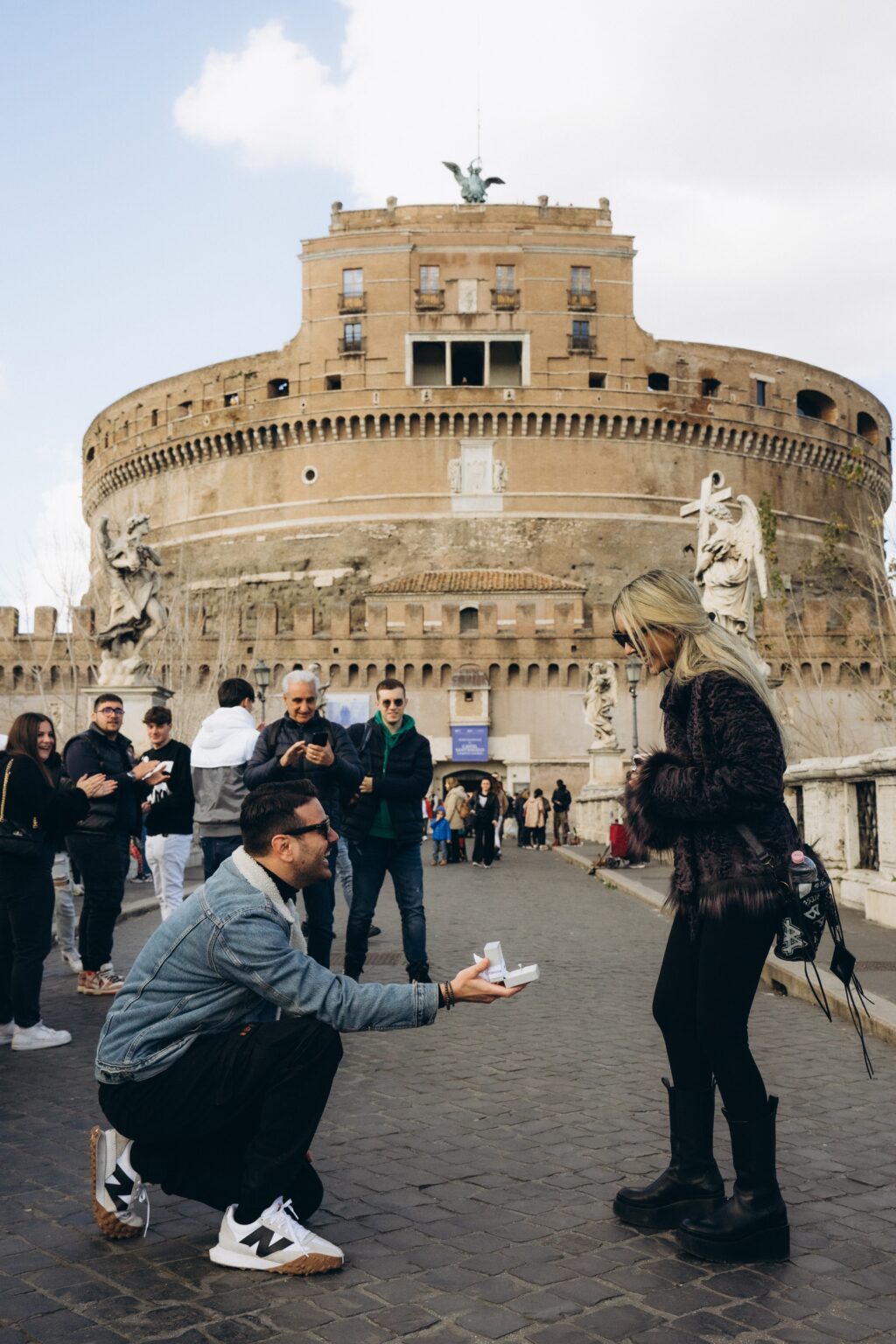 Surprise proposal on Ponte Sant'Angelo with Castel Sant'Angelo behind