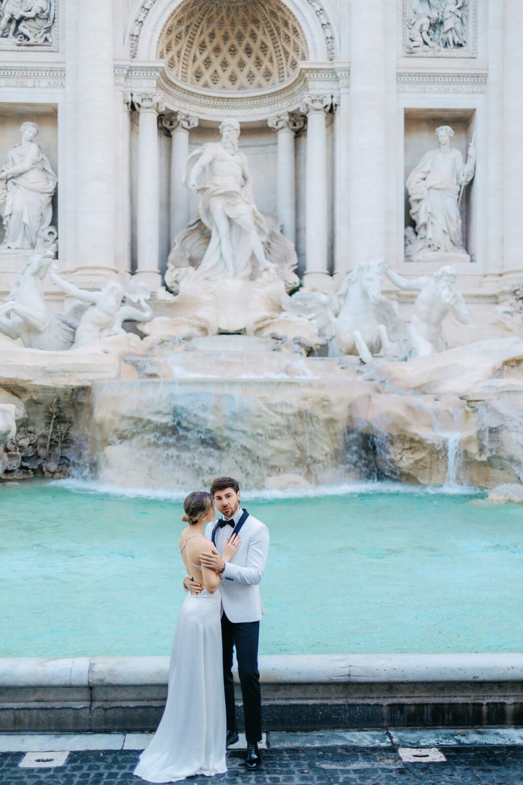 Couple alone at the Trevi Fountain at 7:13 in the morning