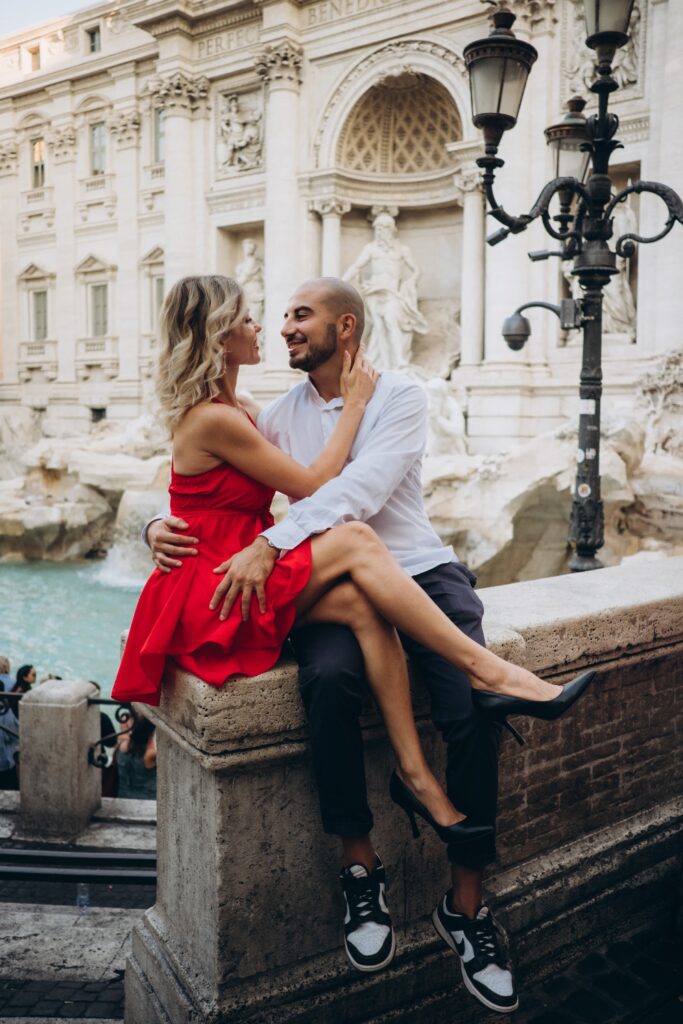 Couple in a red dress at the Trevi Fountain