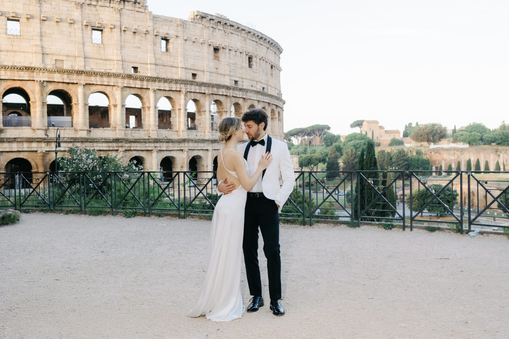 Bride and groom on the empty terrace above the Colosseum