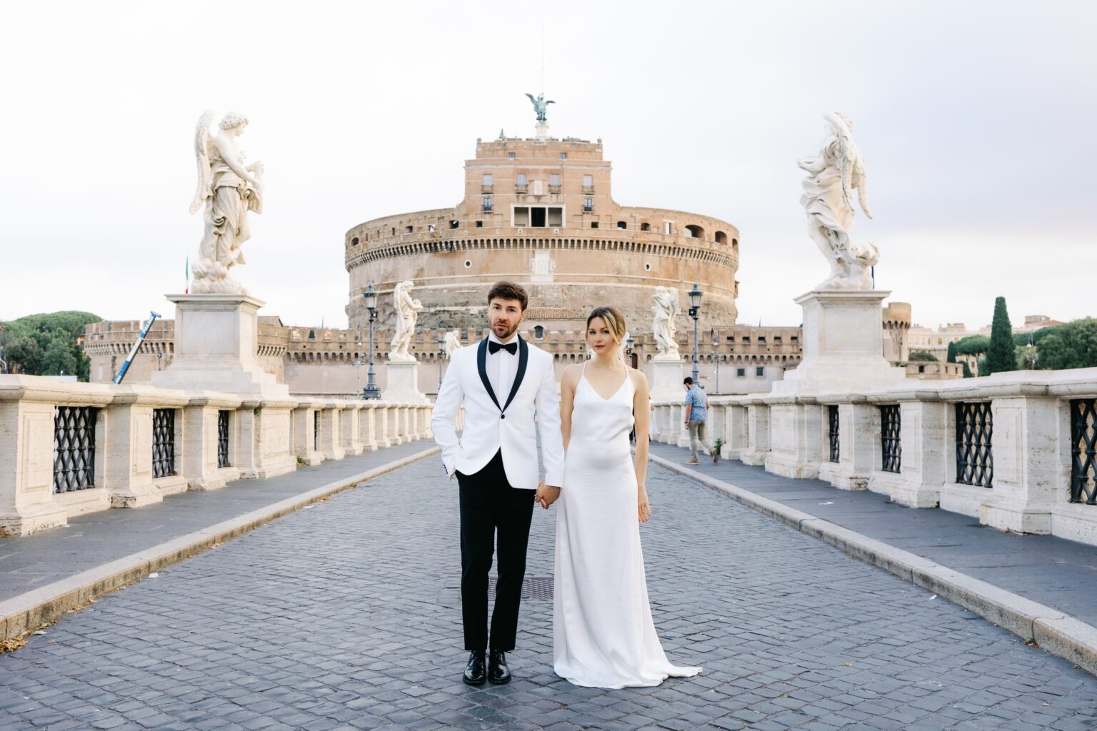 Bride and groom on Ponte Sant'Angelo between Bernini's angels and the castle